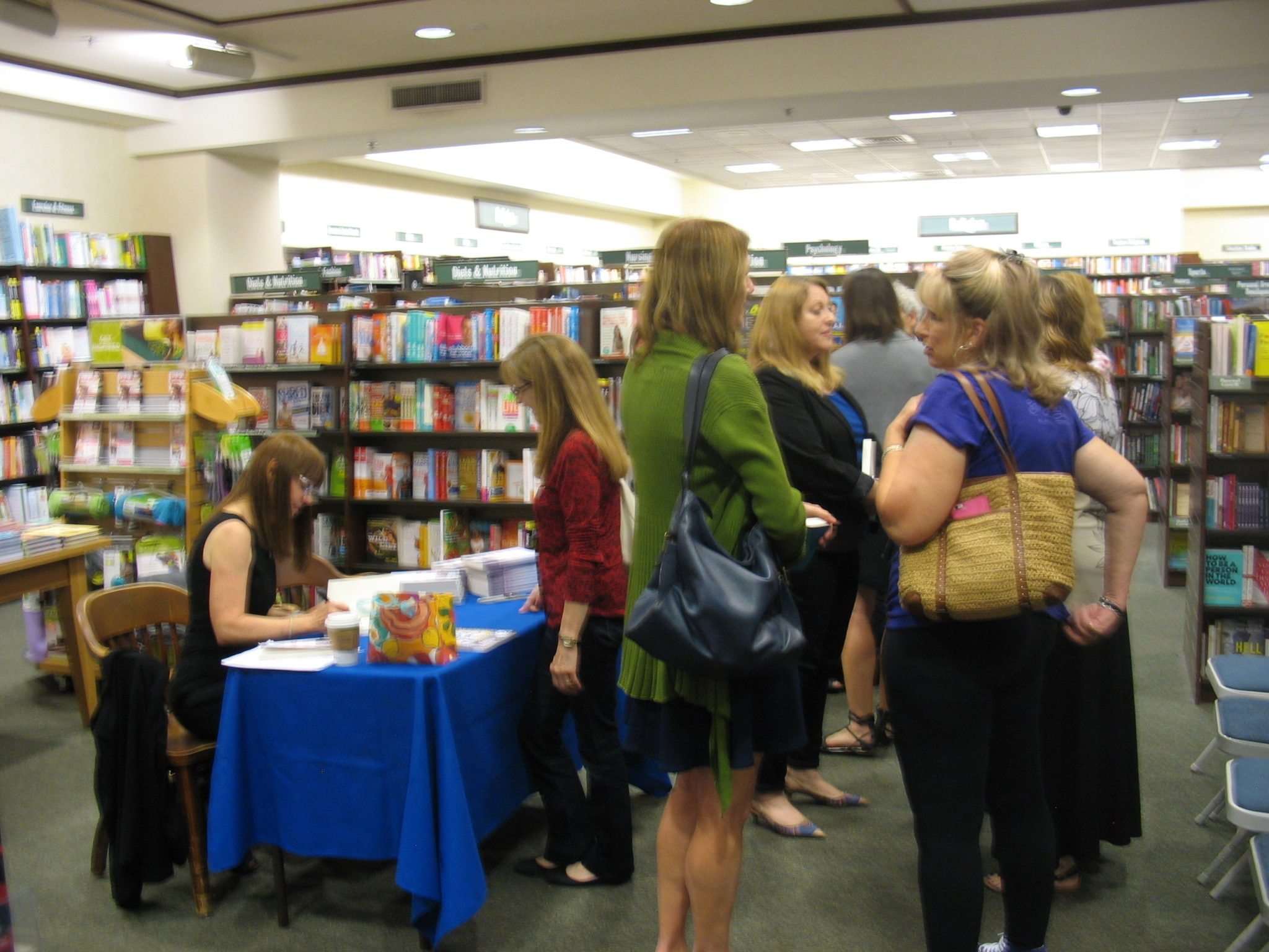 phyllis-signing-books-with-line